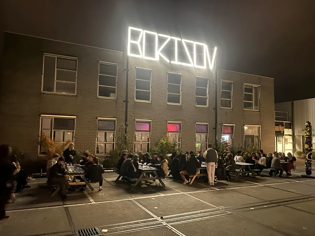 The building with the sign lit and the square full, Borisov Amsterdam